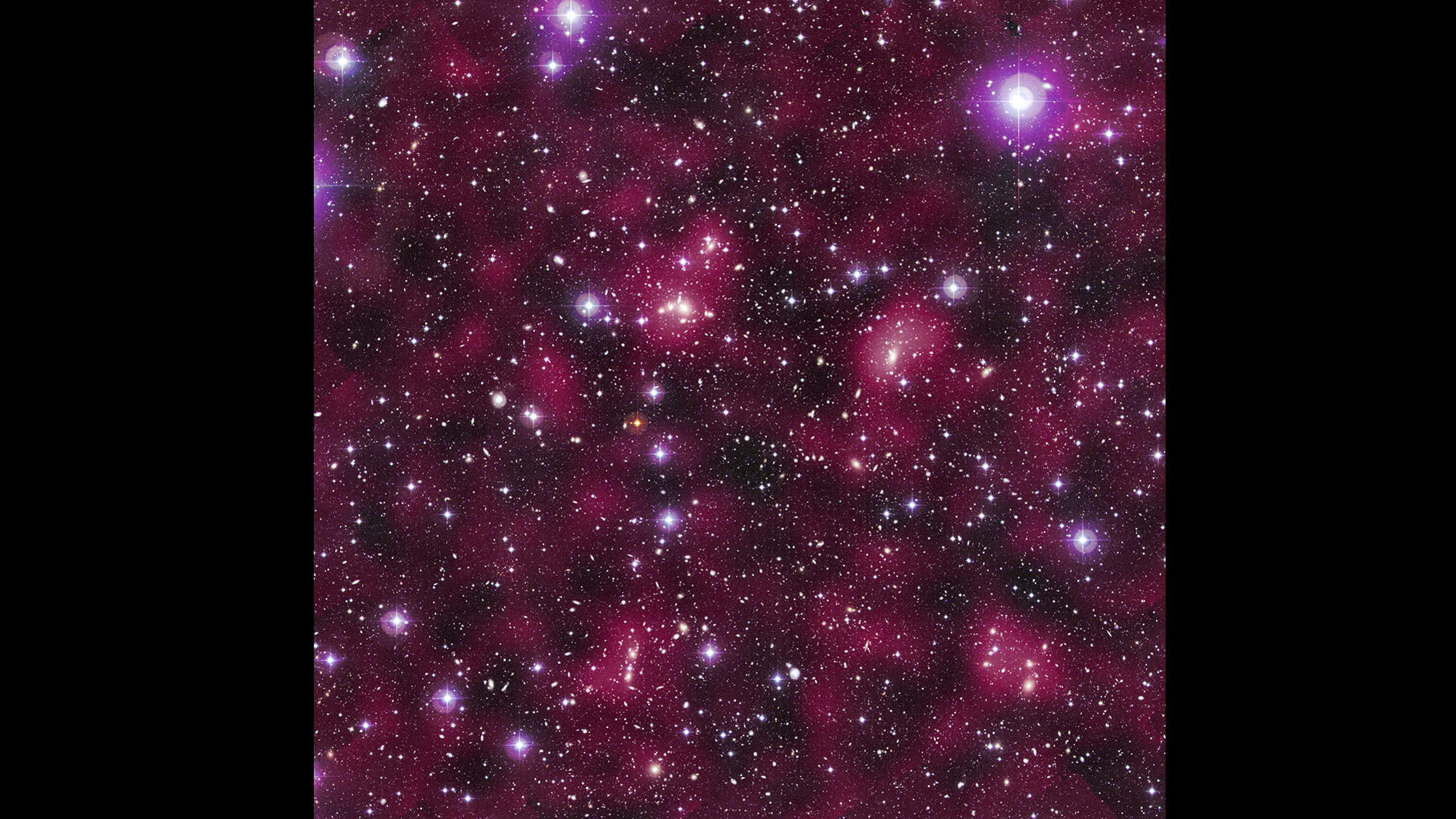 Astronomical image of a sky filled with stars and galaxies against glowing deep purple haze.